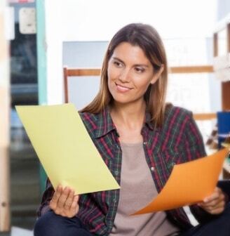 Woman comparing information from two printed documents
